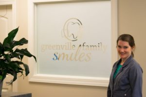 Dr. Goldston in front of the Greenville Family Smiles sign