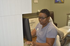 Brenda reviewing a patient's dental information