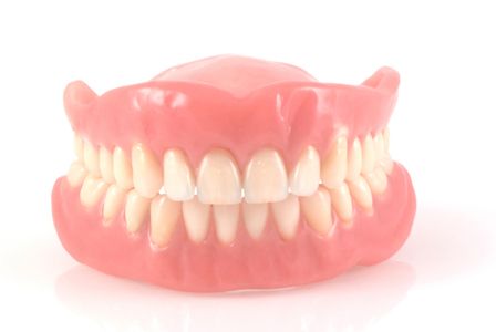 full set of dentures against white background